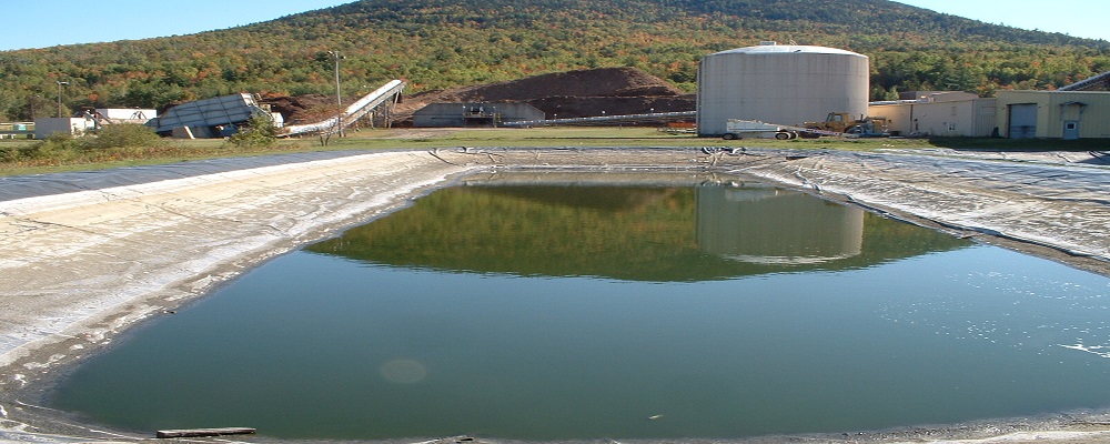 Wastewater Operations & Compliance photo of a large pool of water at an industrial site