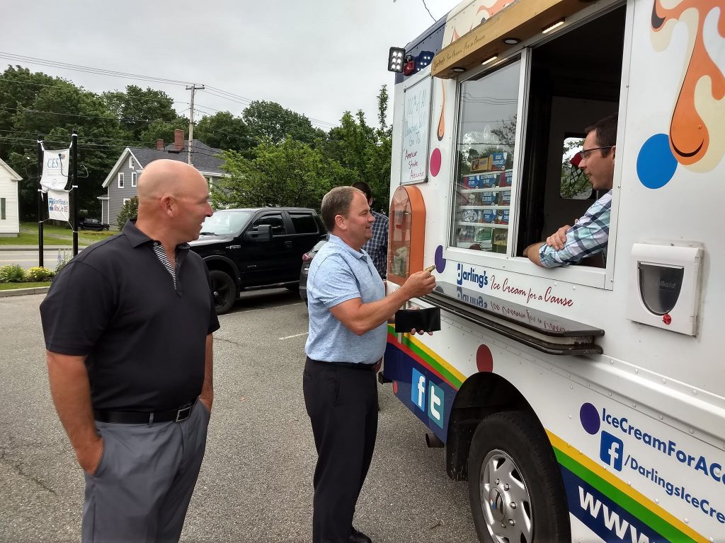 Community Support photo of two men standing at the darling's ice cream truck