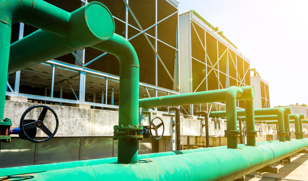 photo of green pipes at an industrial complex