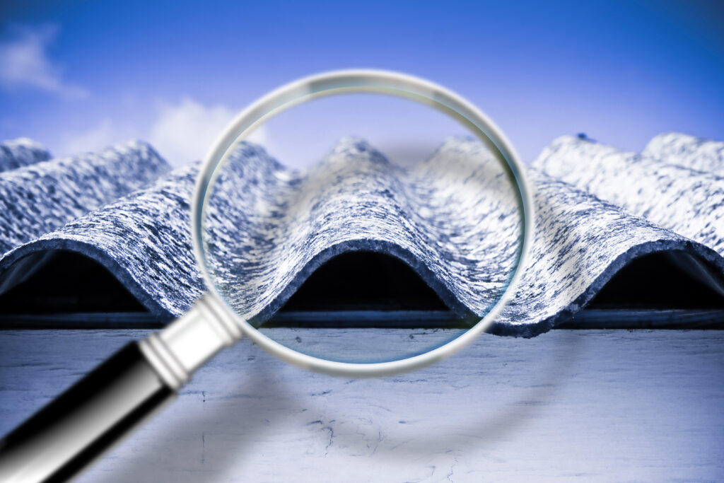 Environmental Compliance graphic of a magnifying glass zooming in on wavy asbestos