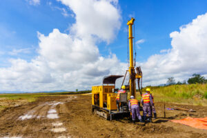 photo of four engineers working on equipment in a large field