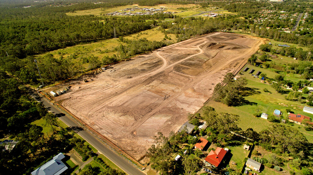 aerial photo of large field covered in dirt