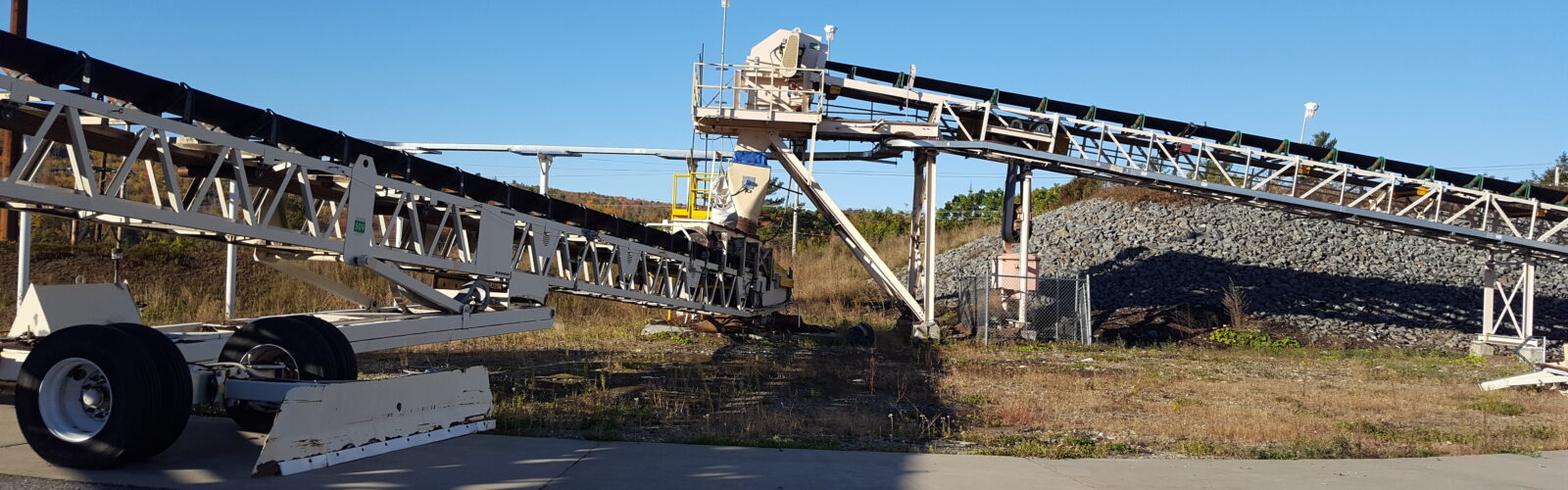 photo of two industrial conveyor belts outside