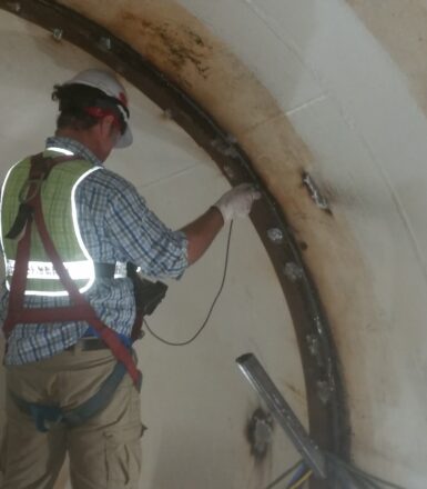 photo of engineer working in a giant pipe