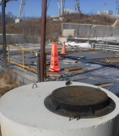 photo of an industrial site with an orange wet floor cone