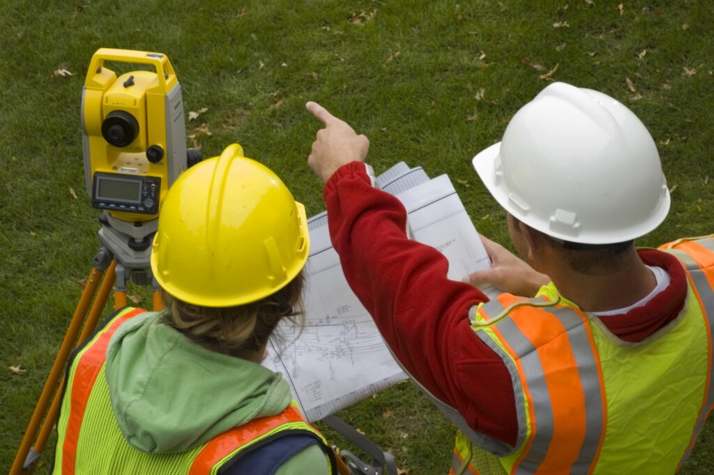 photo of an engineer and surveyor working in the field