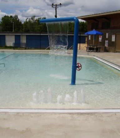 photo of a municipal swimming pool with a water shower