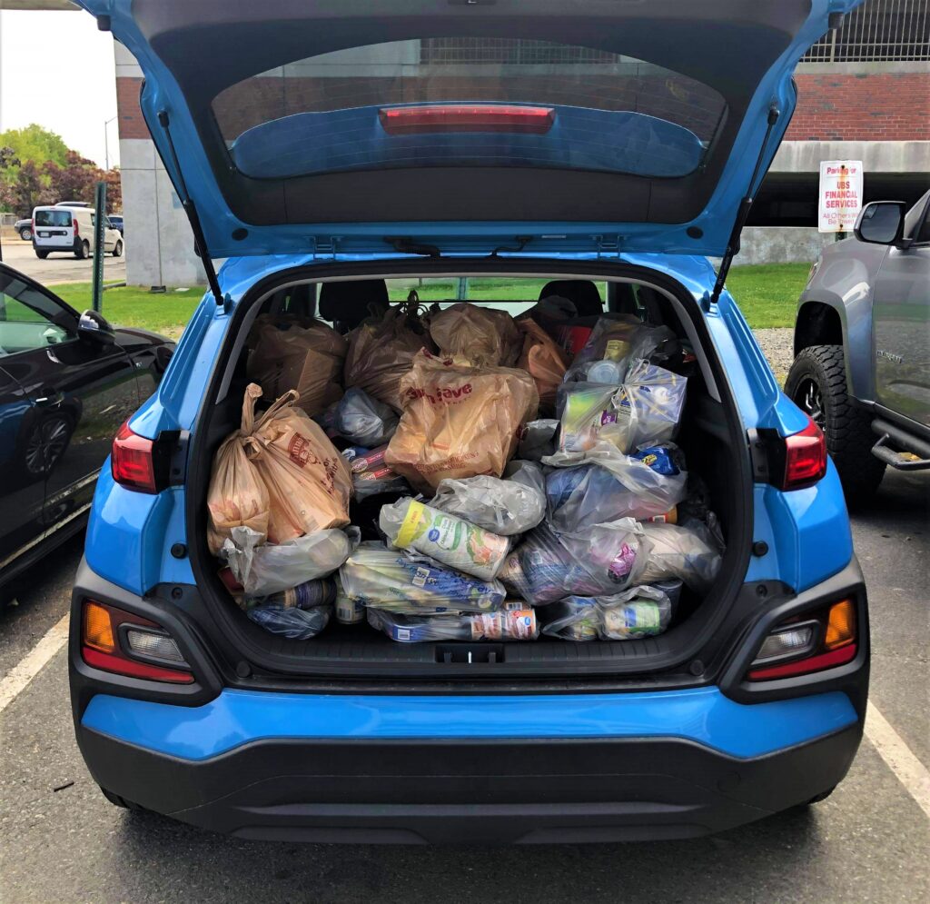 Photo of back of car filled with groceries for the united way drive-thru food drive