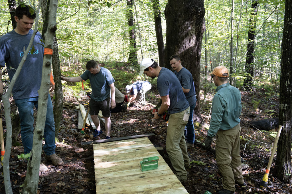 Images of Haley Ward employee-owners and their efforts to expand the trail system at Bauneg Beg Mountain Conservation Area.